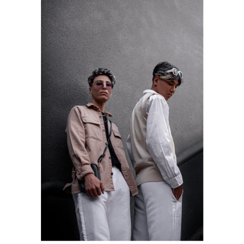 Two young men posing against modern Denver architecture