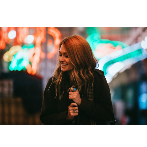 Young woman posing among colorful lights in Seattle