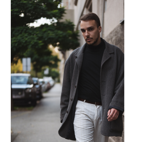 Young man walking for a street portrait in Seattle